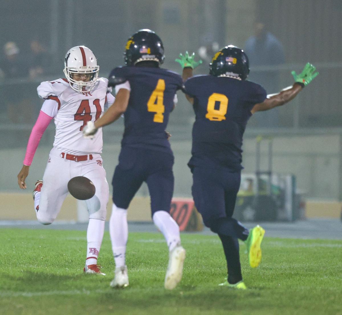 Gabriel Mendez is pressured on a punt by Noah Webber (4) and Andrew Moreno (8). Arroyo Grande beat Paso Robles 40-7 in a high school football game on Oct. 4, 2024.
