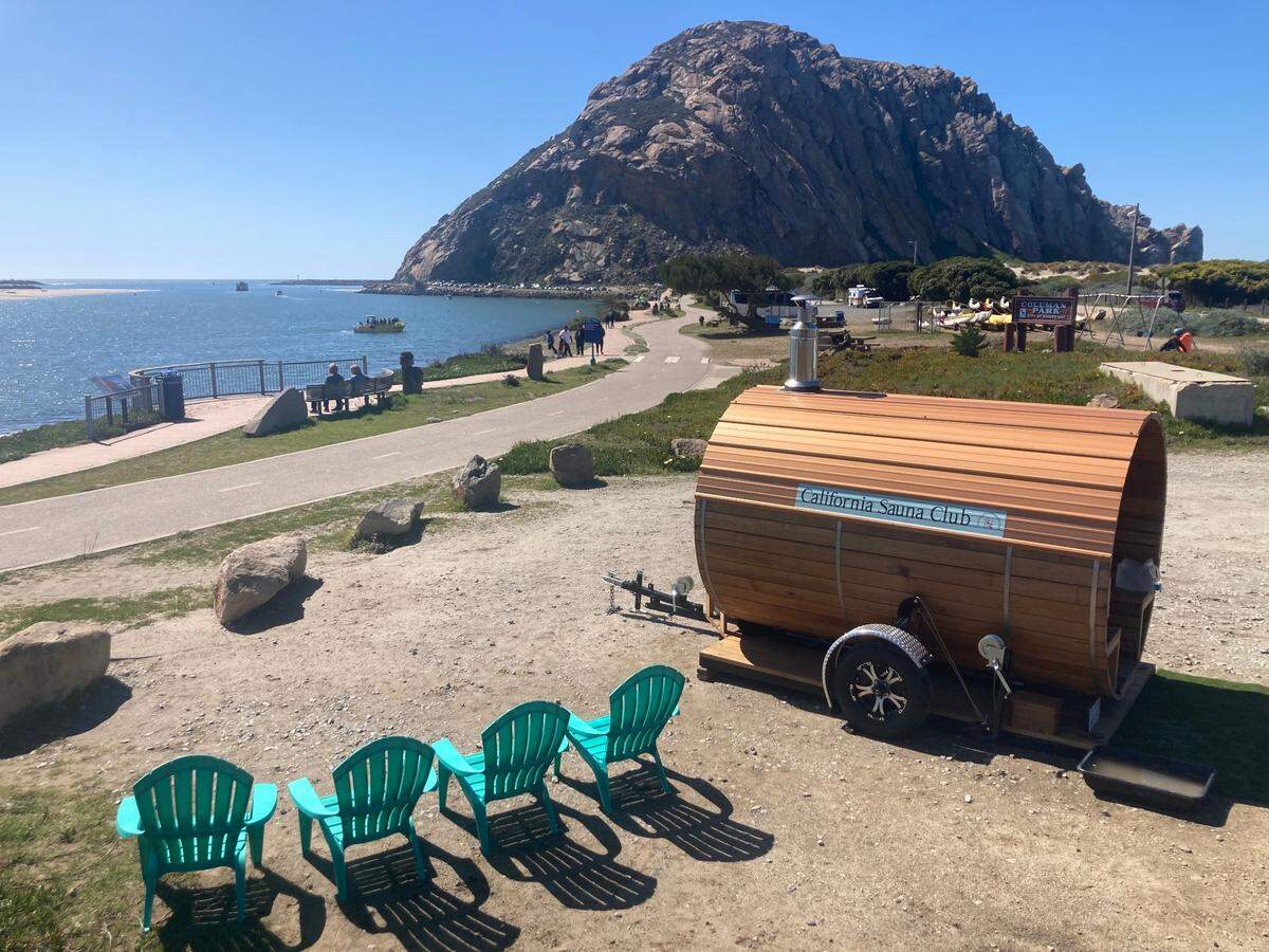 California Sauna Club’s mobile sauna overlooks Morro Rock in its Morro Bay location. Visitors to the new business can take a dip in the ocean in between sauna sessions.