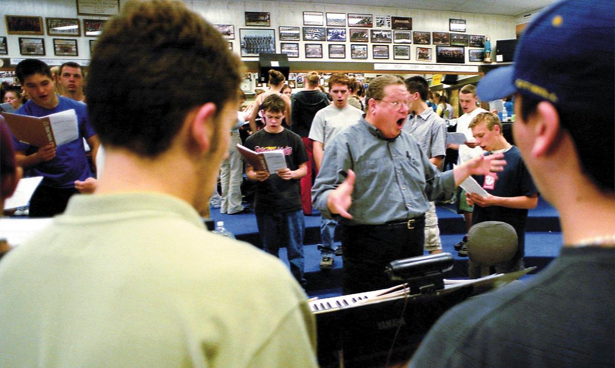 Gary Lamprecht was a two-time winner of the Teacher of the Year for the San Luis Coastal Unified School District. Here, he rehearses a section of the San Luis High School Concert Choir on Nov. 14, 2001. He had numbered speakers lining the room and divided the music up into soprano, alto, bass, etc., so that each group could memorize their part before joining the group.