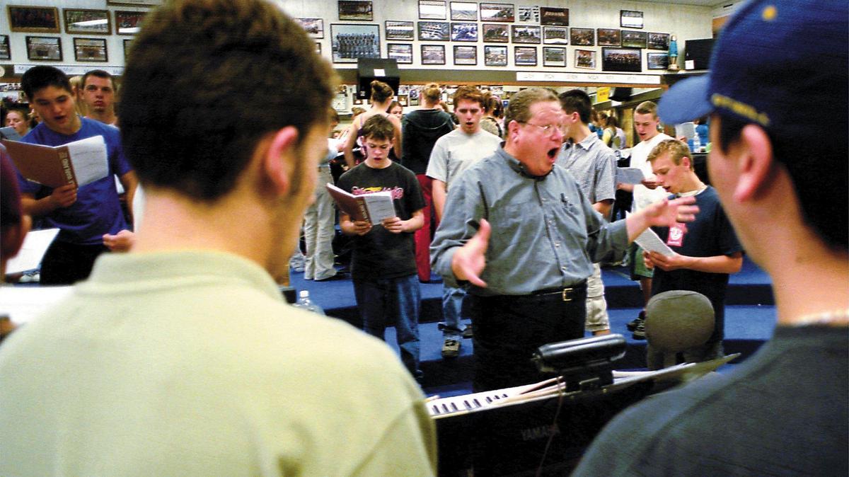 Gary Lamprecht was a two-time winner of the Teacher of the Year for the San Luis Coastal Unified School District. Here, he rehearses a section of the San Luis High School Concert Choir on Nov. 14, 2001. He had numbered speakers lining the room and divided the music up into soprano, alto, bass, etc., so that each group could memorize their part before joining the group.