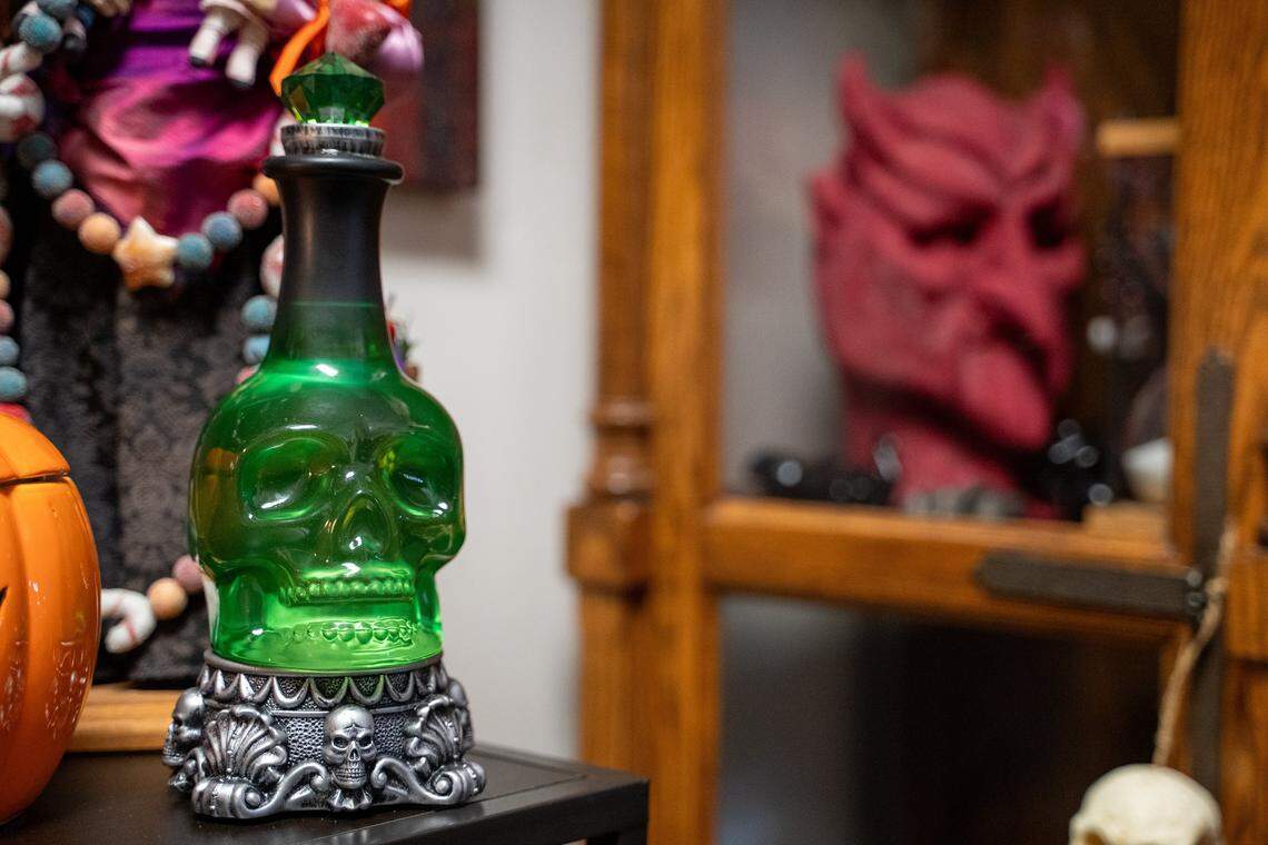 A skull-shaped bottle rests on a shelf at Odd Fellows Antiques Emporium on Tuesday, Nov. 11, 2025. The antique store moved to 1527 W Grand Ave. in August after its 983 W Grand Ave. home was sold to new owners.