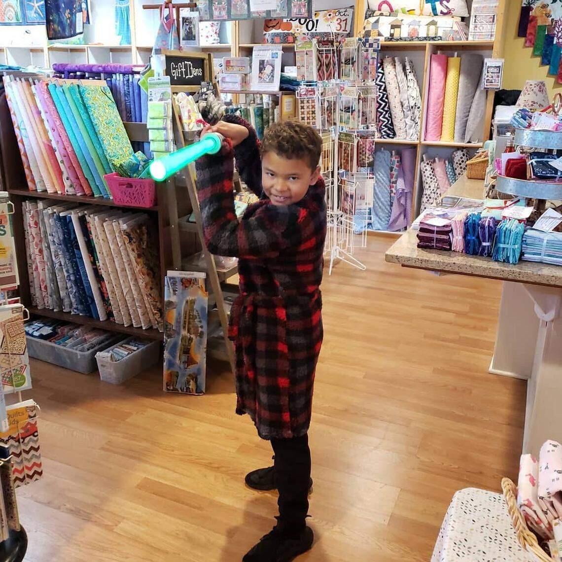 Jeremiah Henderson, son of Alison Virge (co-owner of The Cotton Ball), does his Luke Skywalker imitation at the store during the pandemic. He was raised in the store, according to his mom.