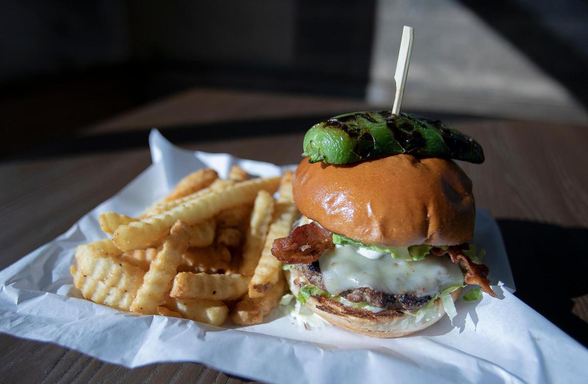 Brooks Burgers recently opened in San Luis Obispo. Pictured is the California Kid made with avocado, bacon, lettuce, grilled onions, tomato, ranch dressing, pepper jack cheese and topped with roasted jalapeno with side a crinkle fries.