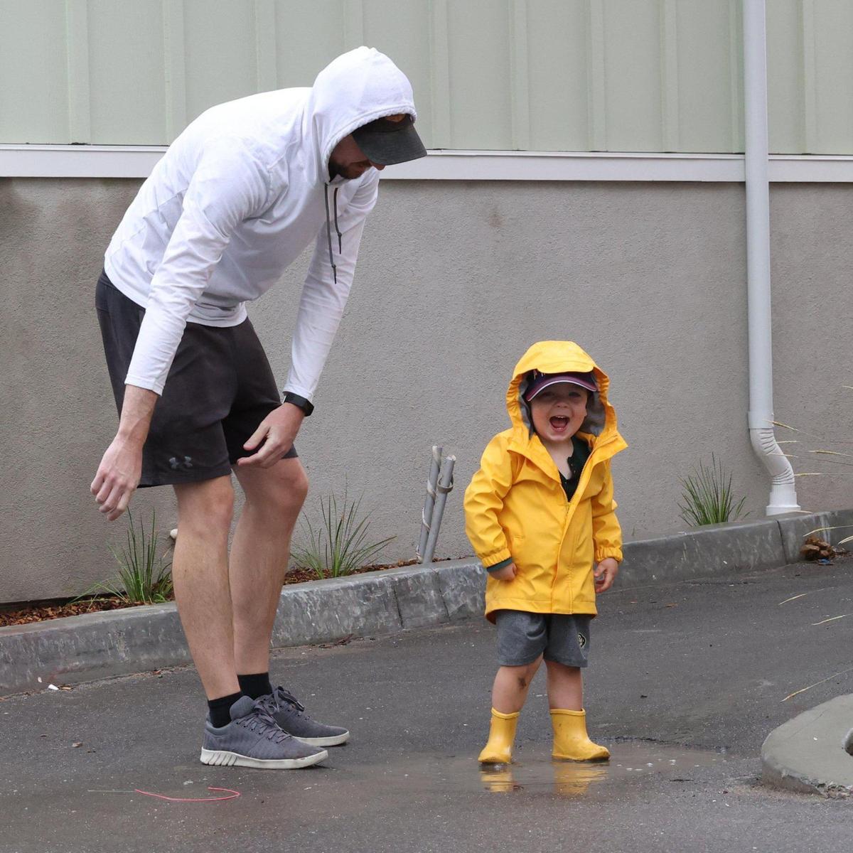Bryan New helps son Bennett, 2, learn the joy of puddle splashing in San Luis Obispo on Monday, Sept. 19, 2022. An early-season rainstorm dropped as much as 1.5 inches of rain in parts of San Luis Obispo County.