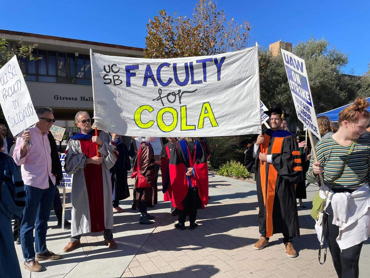 UC Santa Barbara faculty members carry signs in solidarity with the UAW strike on Monday, Nov. 14, 2022. They support a cost of living adjustment for workers.