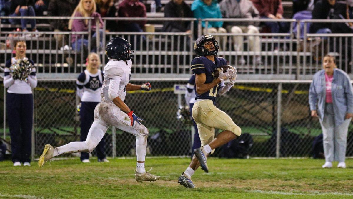 Jamar Howard made this catch and run for a long touchdown pursued by Damian Santos. Mission Prep beat Arroyo Grande 41-35 in a Mountain League football game on Oct. 14, 2022.