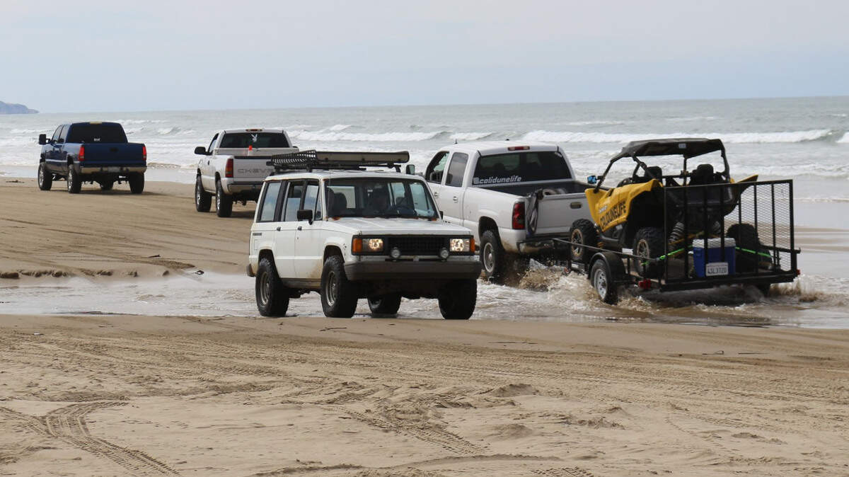 Vehicles cross Arroyo Grande Creek at the Oceano Dunes State Vehicular Recreation Area on Sunday, March 14, 2021. The Coastal Commission’s historic decision bans vehicles from crossing the creek when it’s flowing, which would cut off access to the majority of the park’s off-highway use.