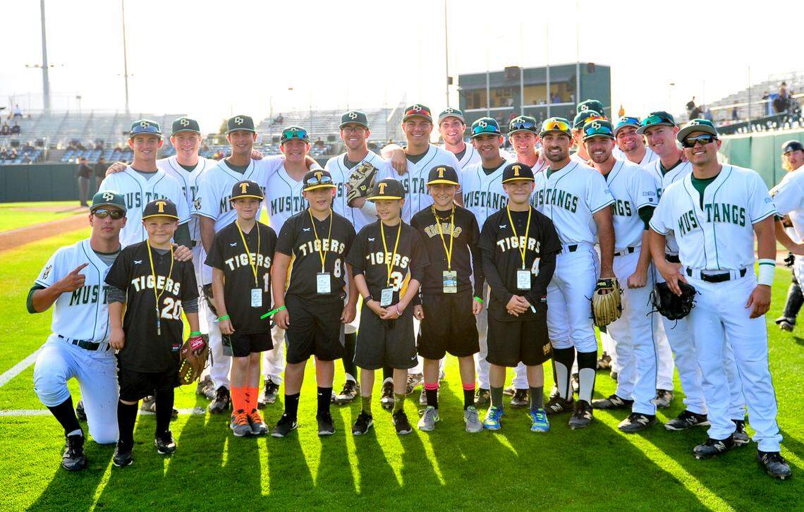 Ryan Tayman (No. 4), pictured in 2016 with the SLO Tigers, poses alongside Cal Poly players before his eventual return to Baggett Stadium.