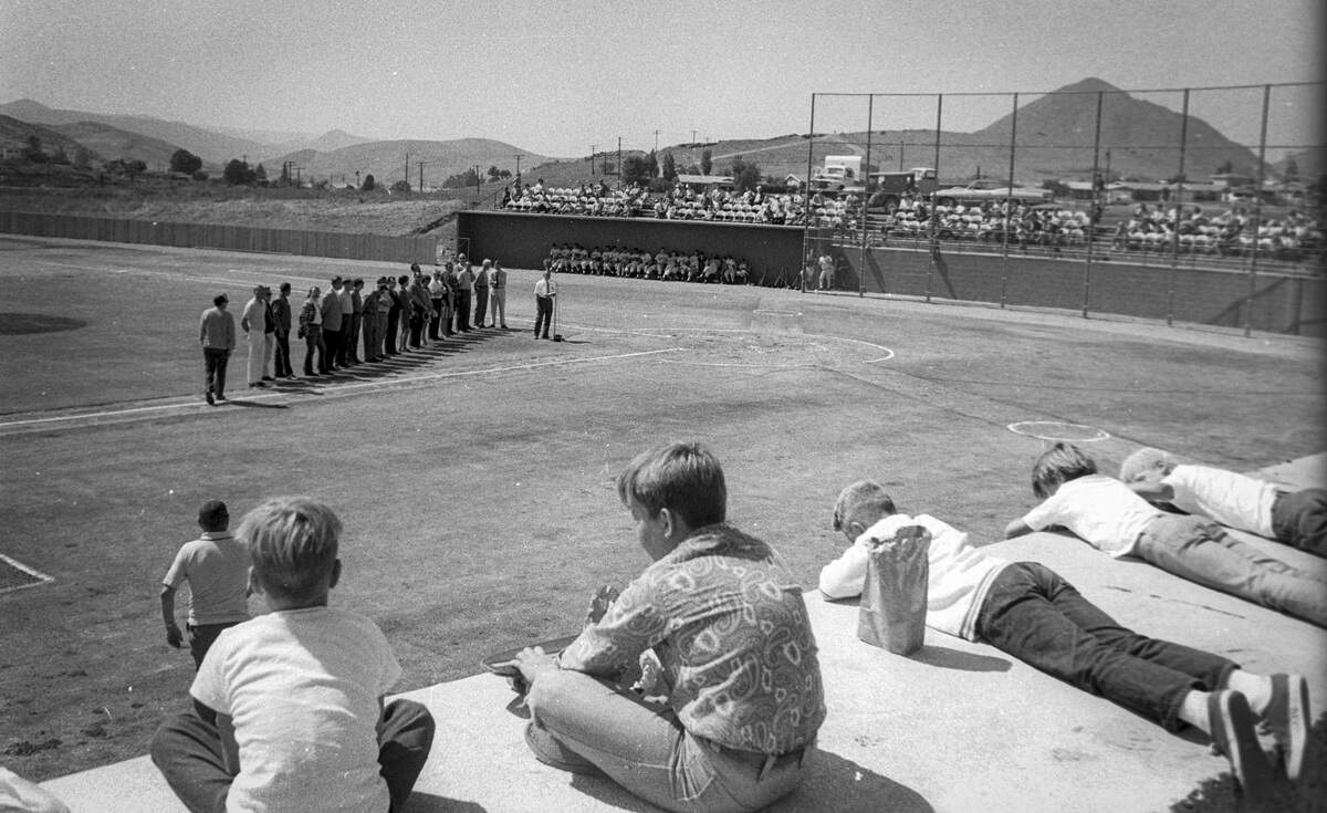 Sinsheimer Stadium opened on Sept. 14, 1970, with an exhibition game. The baseball field is modeled on the major league stadium at Anaheim. Children watch from the dugout roof as volunteers are introduced.