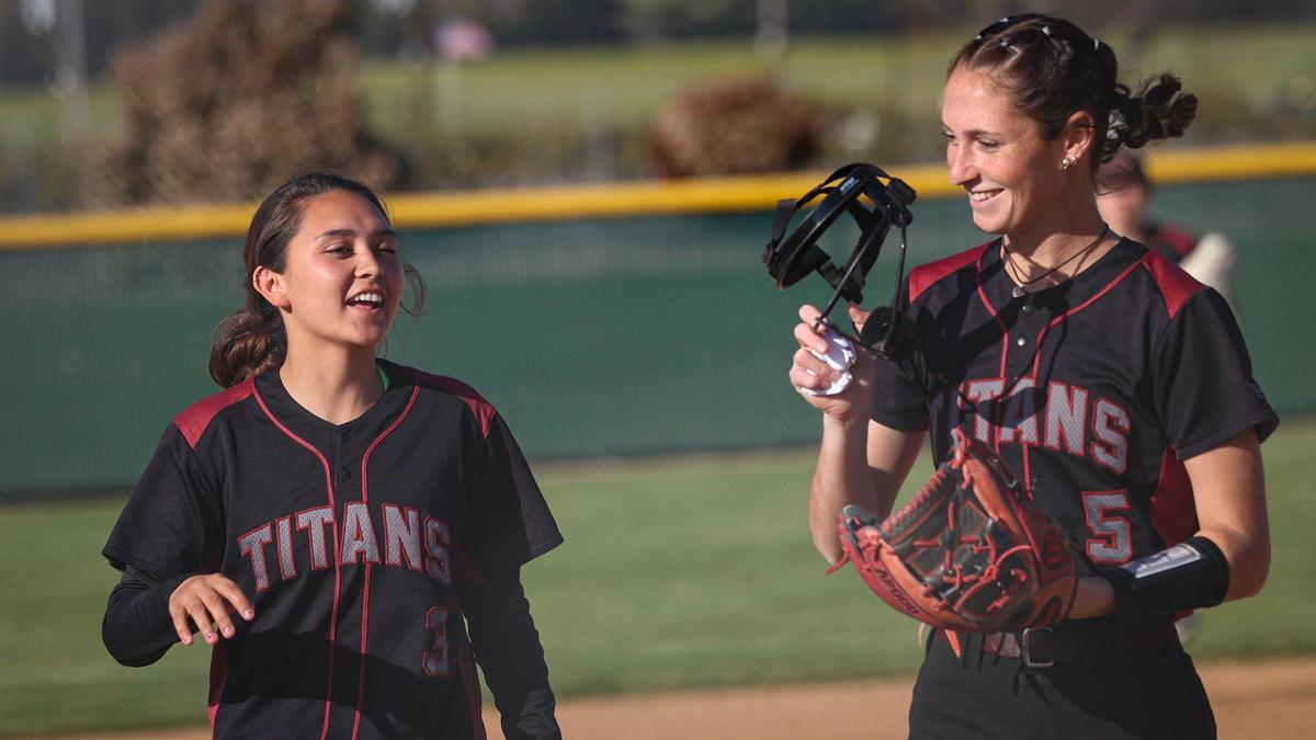 Kate Barnett, right, and Mikayla McKee share a story coming off the field after Barnett threw a shutout inning in Nipomo’s 14-0 win over Santa Ynez on April 19, 2023.