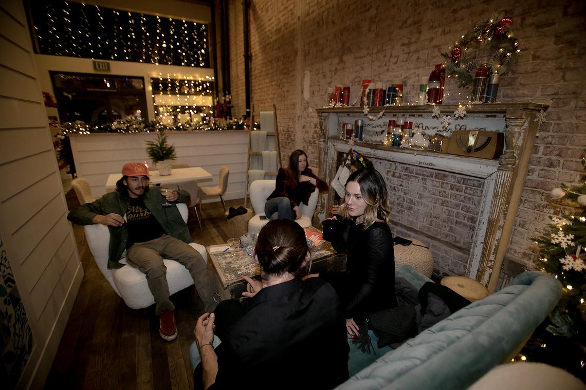During a kickoff party on Tuesday, guests gather in the Cozy Sweater Lounge of The Carrisa, which is running a holiday season pop-up experience in downtown San Luis Obispo. Christmas at the Carissa runs up until Dec. 23.