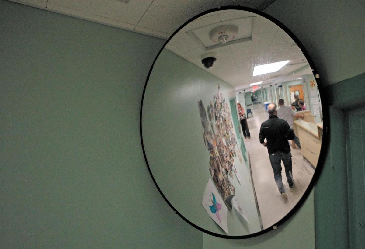 Staff walk in adult residential hallway at the SLO County Psychiatric Health Facility (PHF) in a file photo from Sept. 2, 2015.
