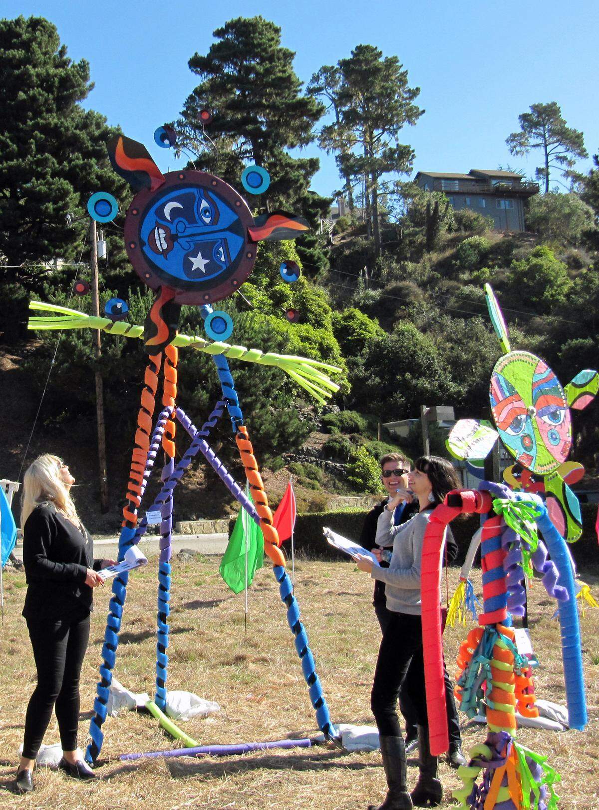 Cambria Scarecrow Festival judges judges, from right, Sarah Linn (The Tribune’s entertainment editor), Dustin Klemann (KSBY Daybreak co-anchor) and Jeanette Trompeter (former news anchor and president of The Foundation at Hearst Castle) evaluate one of the many sculptures around town.