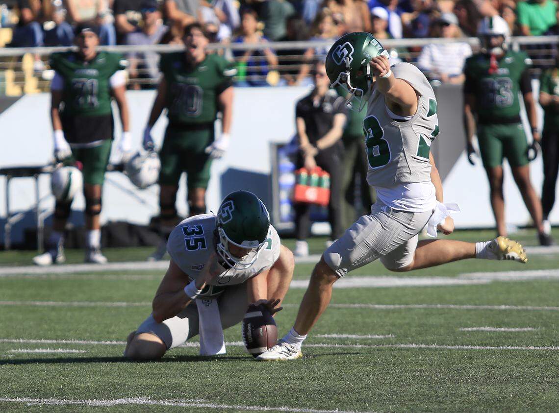 Mustang Jesse Erlich holds the ball while Noah Serna kicks, but misses the goal post. Cal Poly fell to Portland State 40-35 in a college football game at Mustang Memorial Field on Nov.1, 2025.