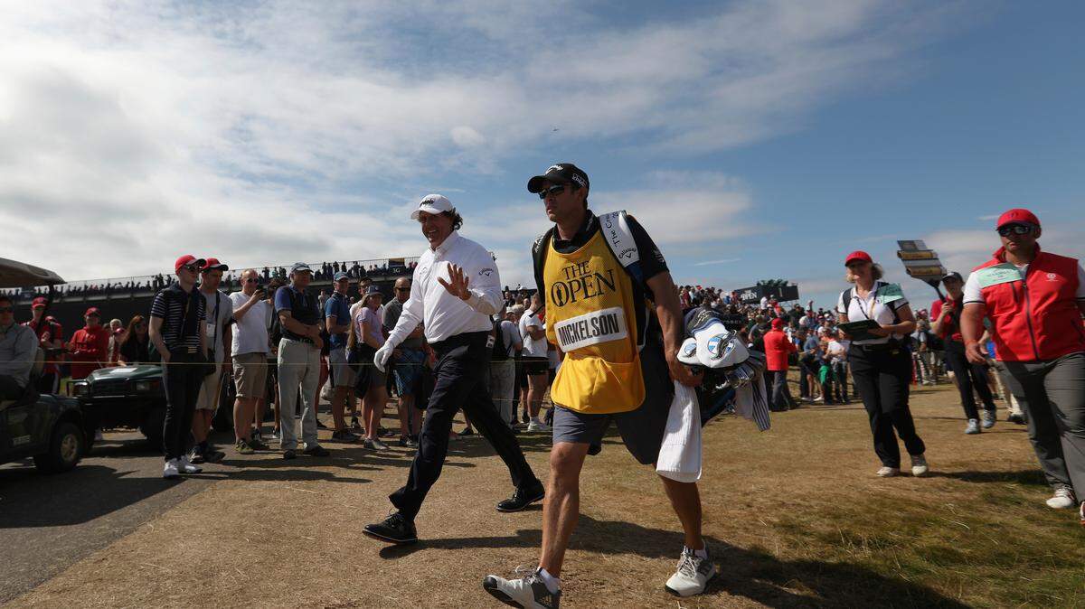 Phil Mickelson walks from the first green to the second tee box with his caddie Tim Mickelson during the final round of the British Open Golf Championship in Carnoustie, Scotland, July 22. Tim Mickelson will play in the Straight Down Fall Classic in San Luis Obispo, California, on Saturday and Sunday.