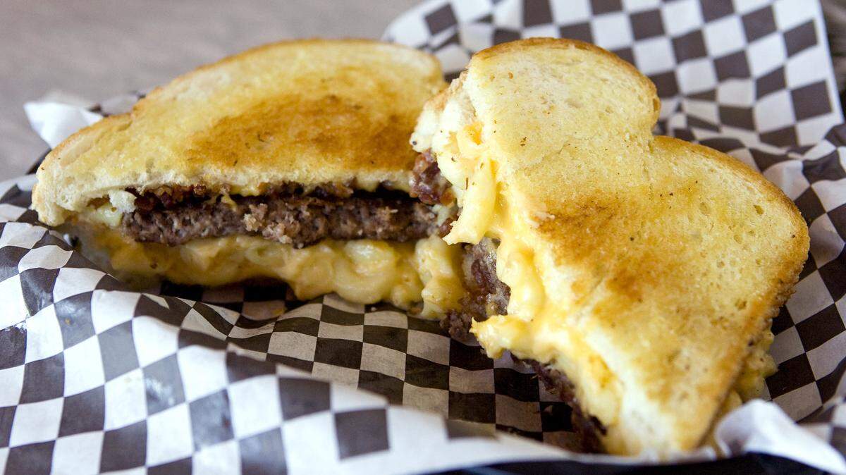 The Macaroni Bacon Cheeseburger at Dan's The Grub Shack combines three classic comfort foods: grilled cheese, a burger, and macaroni and cheese.