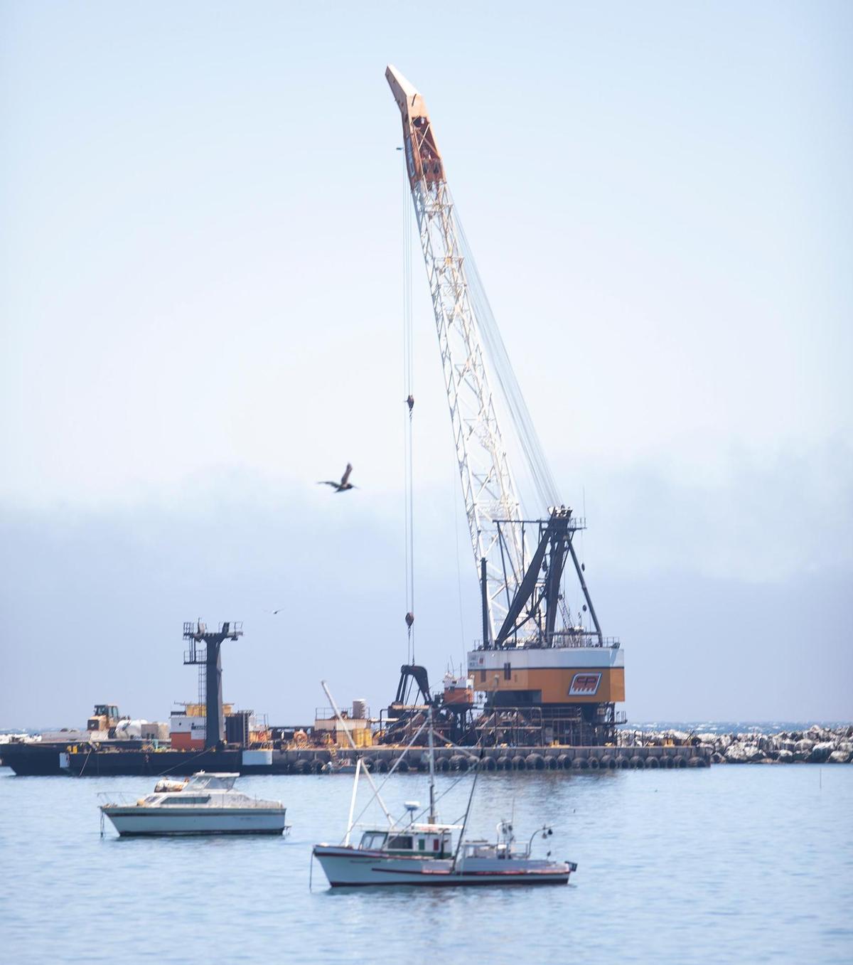 A 265-foot crane is working on the breakwater at Port San Luis, on Saturday, July 8, 2022.