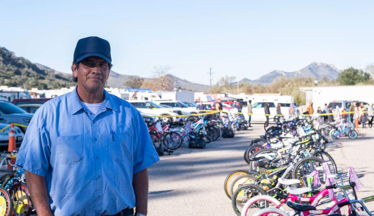 San Luis Obispo County Jail inmate Michael Tidd at the San Luis Obispo County Sheriff’s Office bicycle giveaway on Dec. 13, 2022. Tidd helps repair the bikes to give to low-income families in the county.