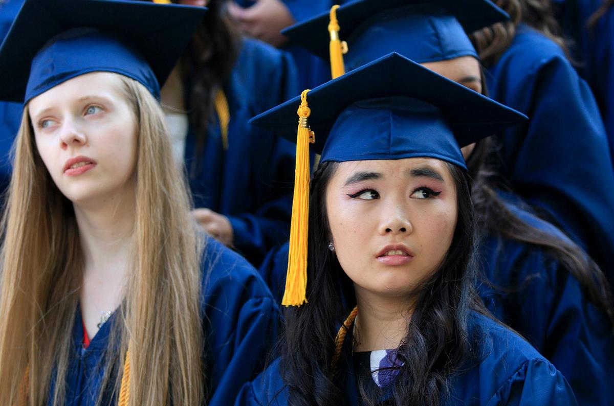 Mission Prep graduation. Sixty-nine seniors graduated Friday at Mission Prep high school in San Luis Obispo, California. The students will enter a host of California colleges, including University of California schools and Cal Poly. A class photo was taken in front of the school just before the ceremony. Julie Walker, right, looks pensively off into the distance. (Laura Dickinson)