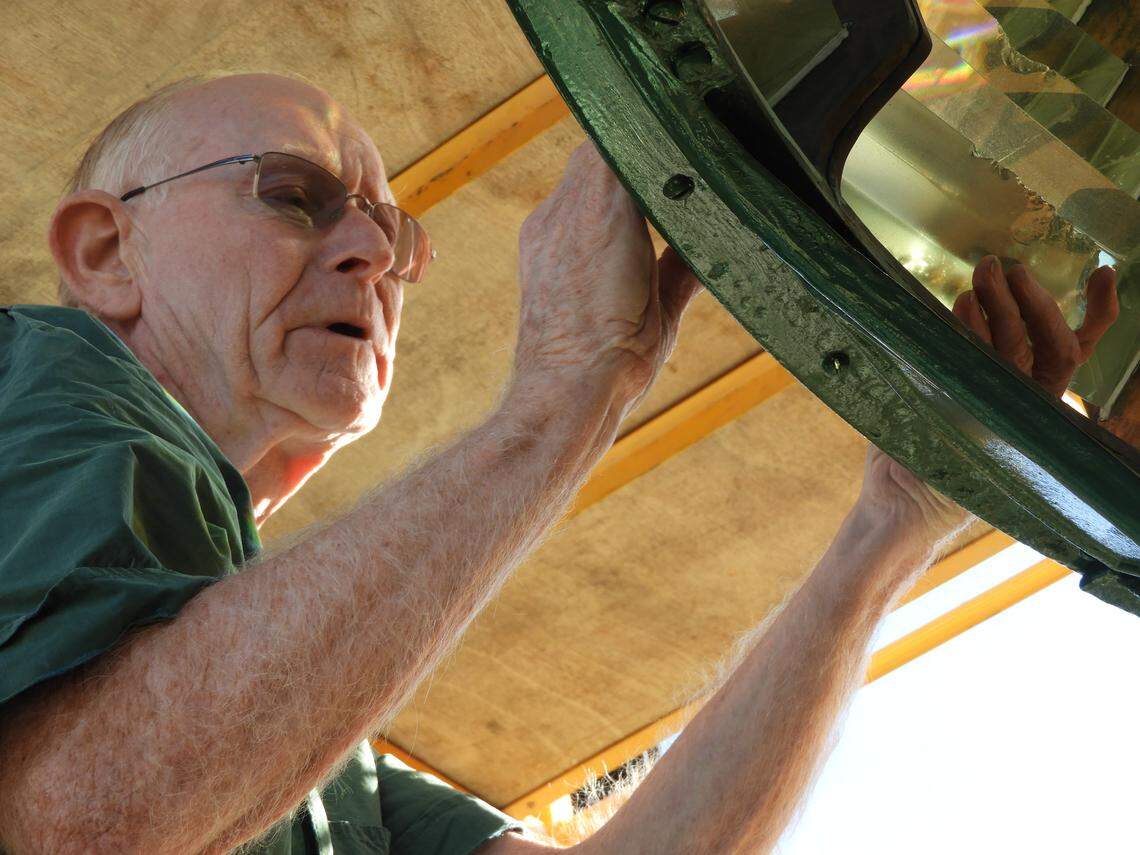 Expert lampist Jim Woodward determines where a broken prism fits during cleaning of the Piedras Blancas Lighthouse lens in Cambria.
