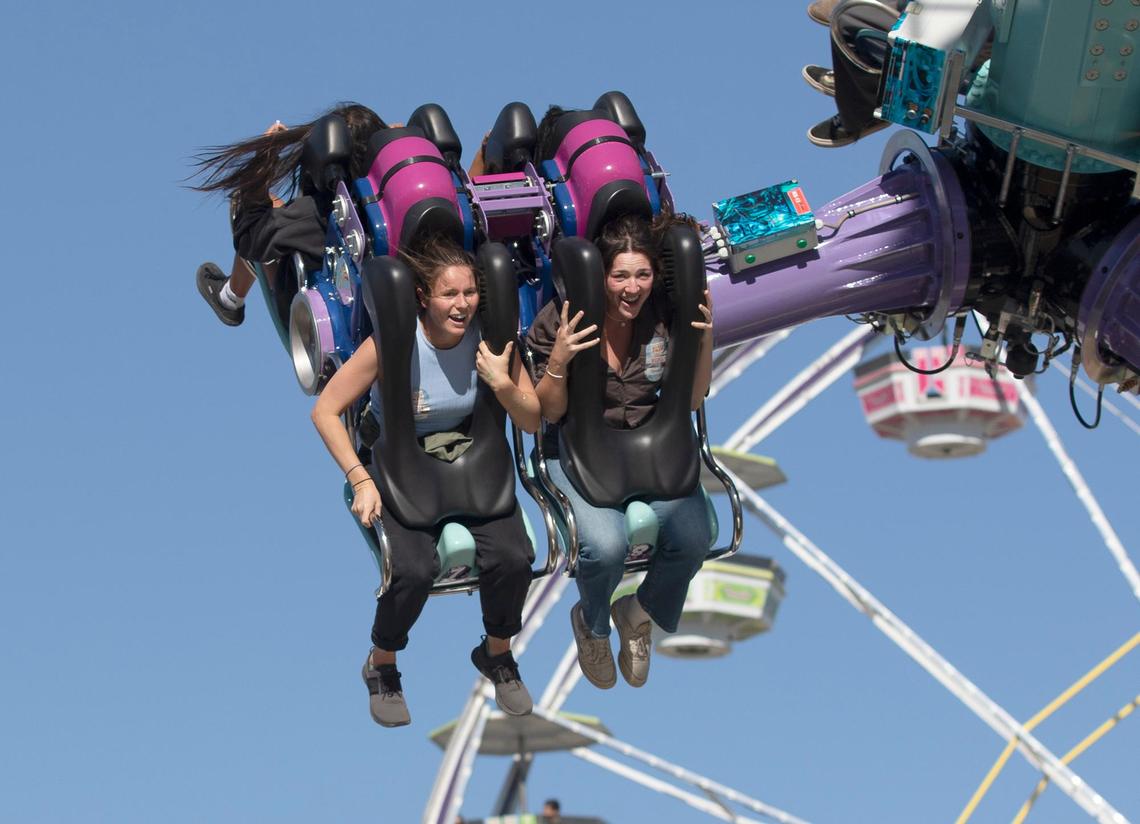 Tribune reporters Chloe Shrager and Kelsey Oliver take on this year’s rides, games and food at the 2024 Mid-State Fair. The Paso Robles fair opened Wednesday, July 17, 2024. Oliver, left, and Shrager scream and laugh on the Black Out ride.