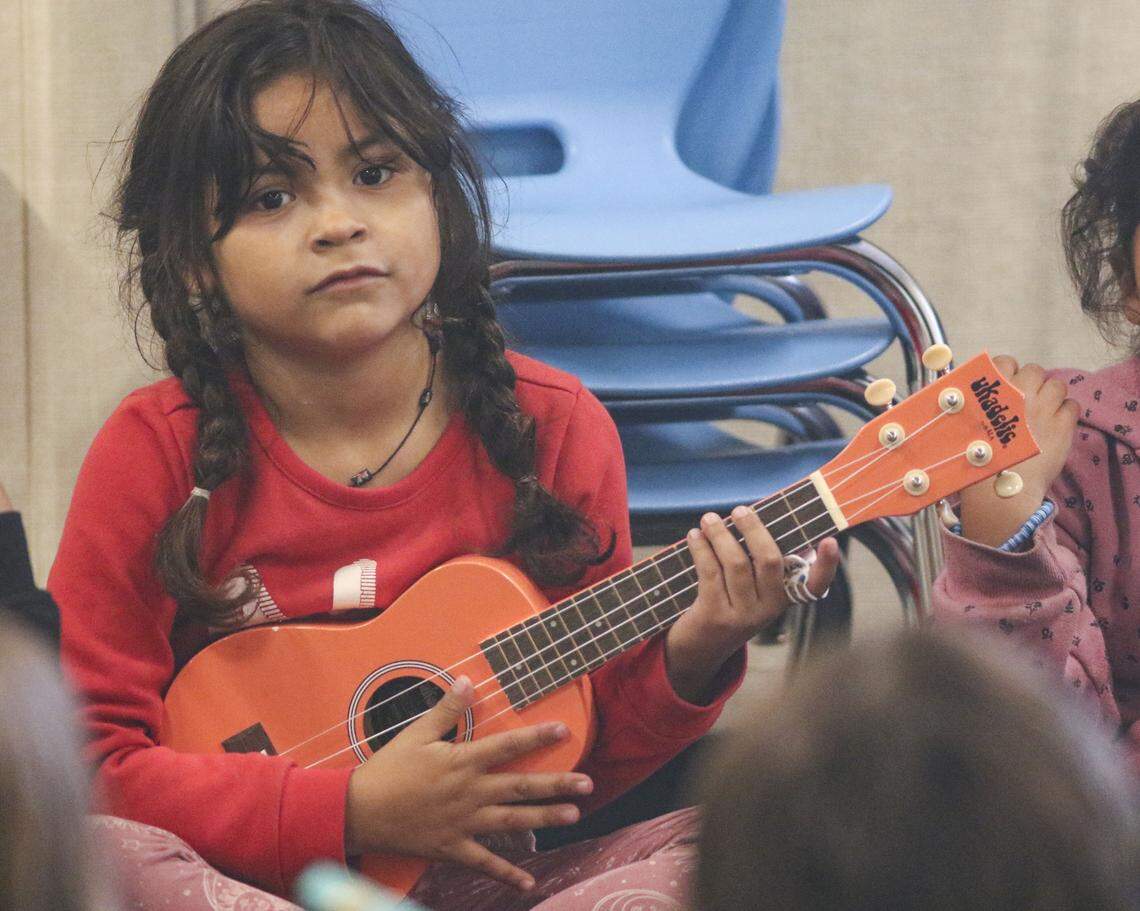 Aranza Cordova, a first grader, strums ukelele along with the class. Infinite Music program at Mary Buren Elementary School in Guadalupe; Jody Mulgrew is the teacher, on Oct. 8, 2025.