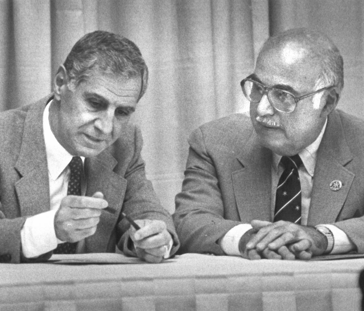 Gov. George Deukmejian signs a bill requiring minimum law enforcement experience and education for sheriffs in California as San Bernardino County Sheriff Floyd Tidwell watches in March 1988.