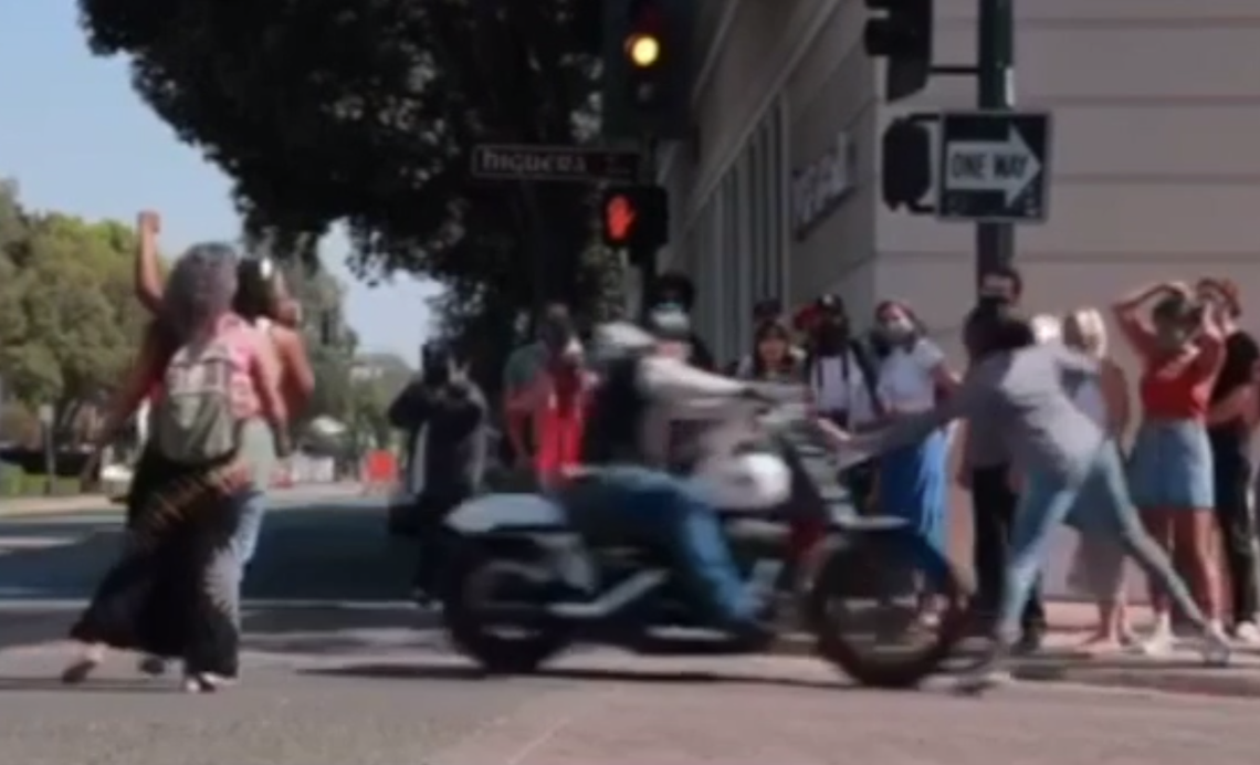 A motorcyclist drives into Black activists protesting on Higuera Street in San Luis Obispo on Wednesday.