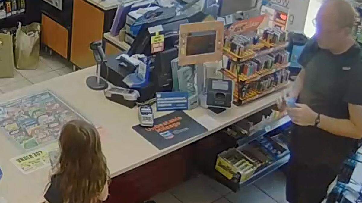 A surveillance photo from the Chevron gas station at 3180 Broad St. shows Jonathan Davis standing behind a girl at the counter on June 23.  Police say he approached the girl, rubbed his fingers through her hair then left the store.