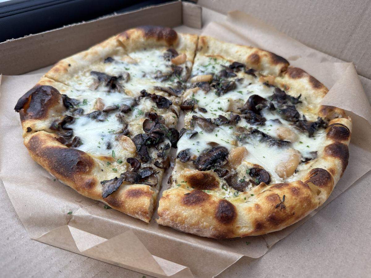 A pizza topped with shaved mushrooms, ricotta, garlic confit and thyme from Wayward Baking in Los Osos.