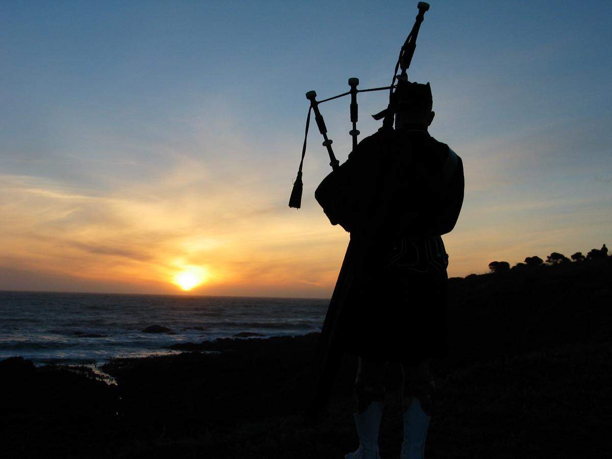 Cambria resident Neal Dundas plays his bagpipe on a blufftop overlooking Otter Cove at Fiscalini Ranch Preserve.