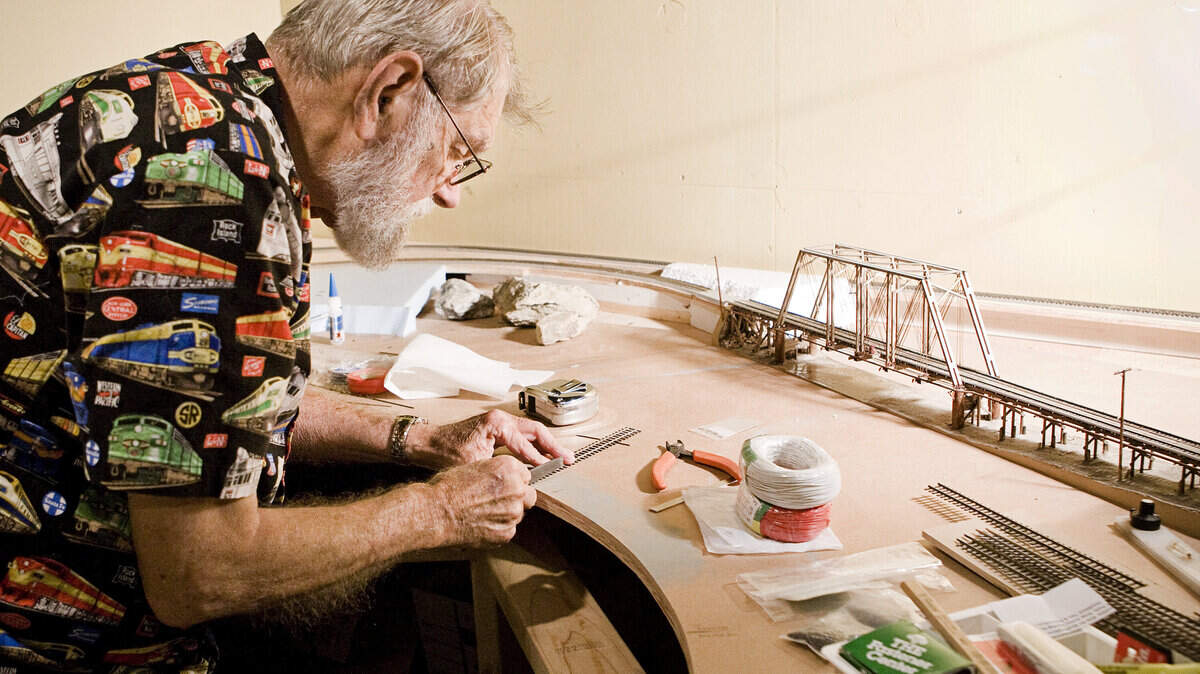 John Marchetti works on a piece of track that will be part of the Avila Beach model railroad during preparations in September for the Oct. 12 grand opening of the San Luis Obispo Railroad Museum.