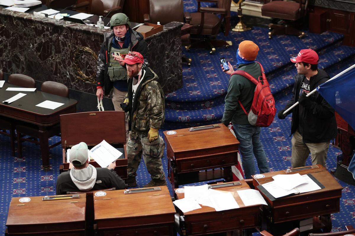 Protesters enter the Senate Chamber on Wednesday, Jan. 6, 2021 in Washington, D.C. Congress held a joint session today to ratify President-elect Joe Biden’s 306-232 Electoral College win over President Donald Trump. A group of Republican senators said they would reject the Electoral College votes of several states unless Congress appointed a commission to audit the election results.
