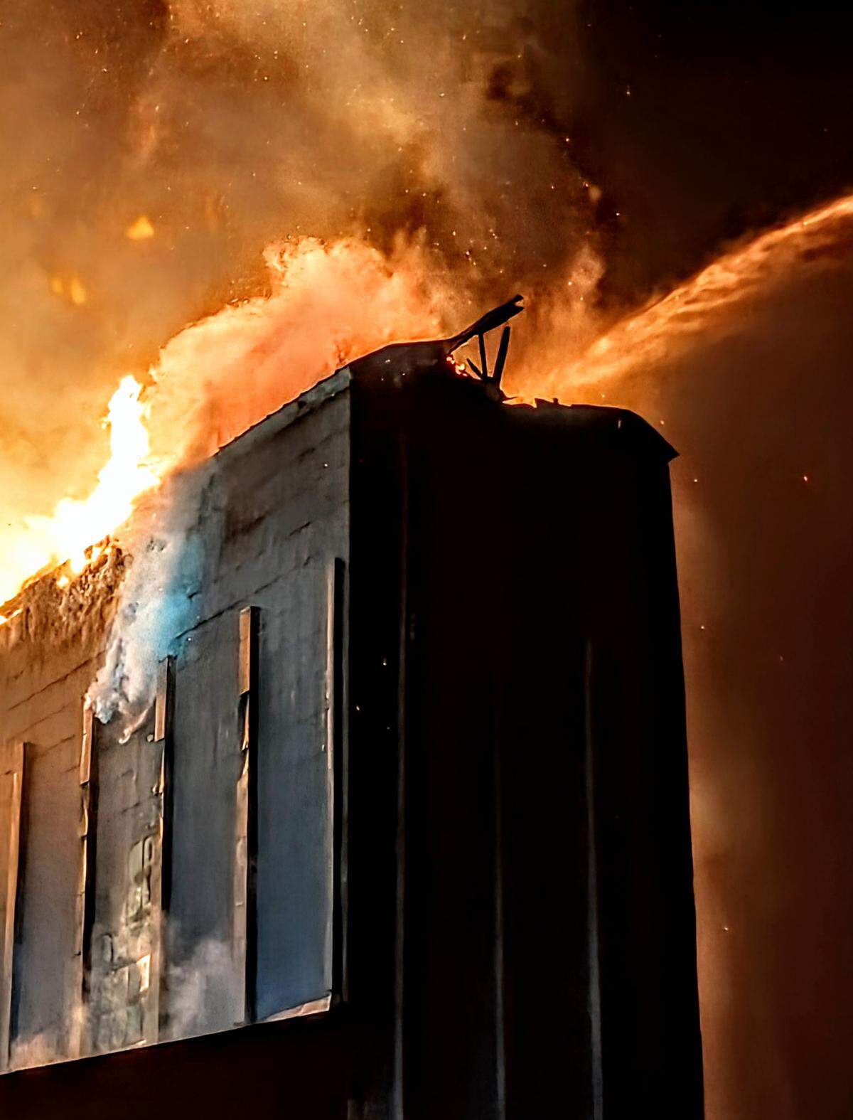 Fire burns through Templeton Feed & Grain in downtown Templeton on July 4, 2025.
