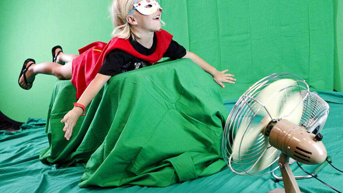 Jack Tripp, 4, soars through the air — with the help of fans and a green screen — during Super Hero School on Tuesday at the Paso Robles City Library.