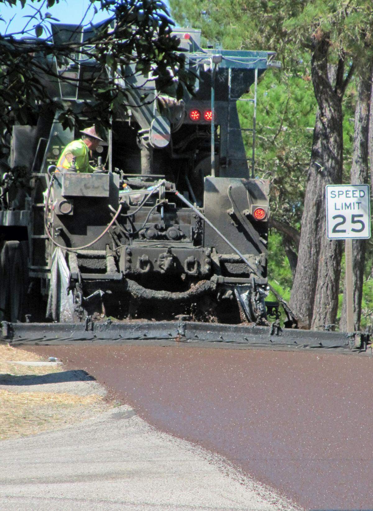 A microsurfacing machine works on Ellis Avenue in Cambria.