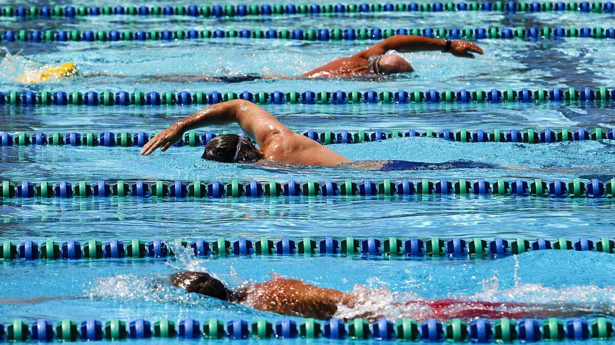 Swimmers swim laps at the SLO Swim Center in San Luis Obispo. Retired therapist Linda Lewis Griffith plans to swim 100 miles at the pool in 2019.