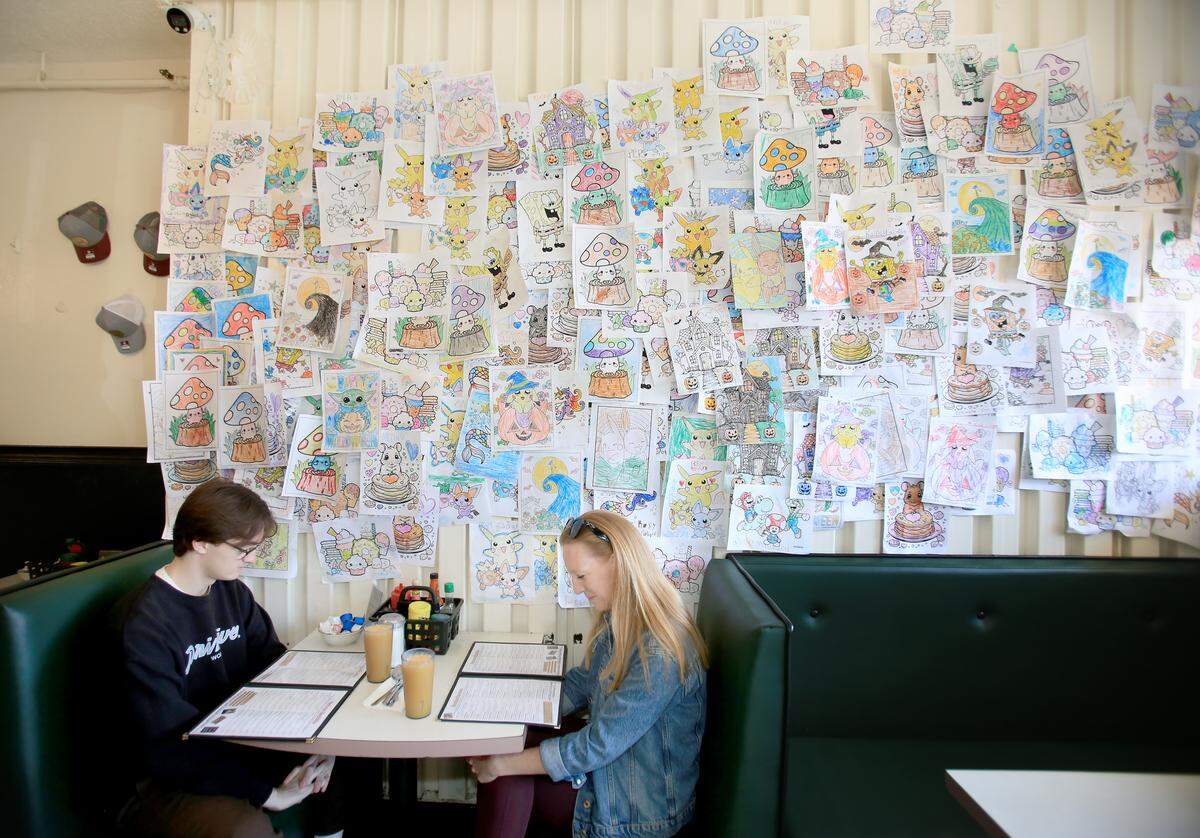 Cal Poly student Ian Juvinall and his mom, Sandy Juvinall, of San Clemente, get ready to order their breakfasts from the big menu at Louisa’s Place in downtown San Luis Obispo. Louisa’s formerly was named The Best Ever Grill, but was renamed Louisa’s Place in 1976. The restaurant has been at 964 Higuera St. in downtown San Luis Obispo since the diner opened in 1958.