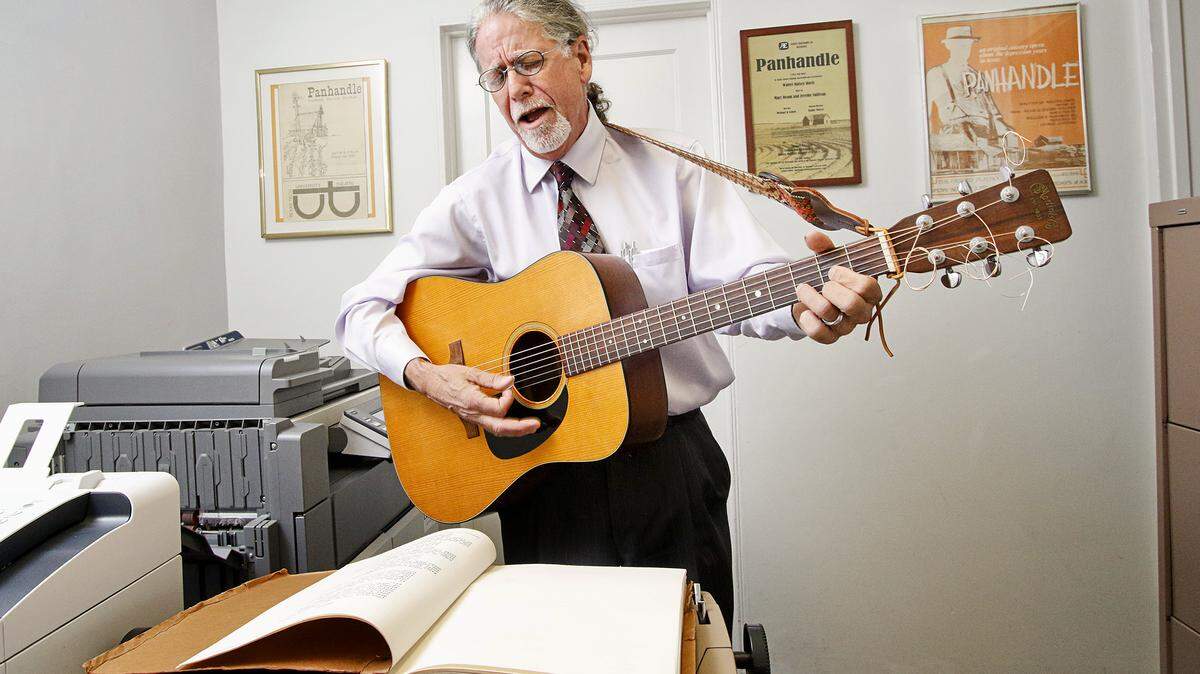 Lawyer Jere Sullivan performs a song from the musical "Panhandle," which he co-wrote in the 1970s, at his San Luis Obispo law office.
