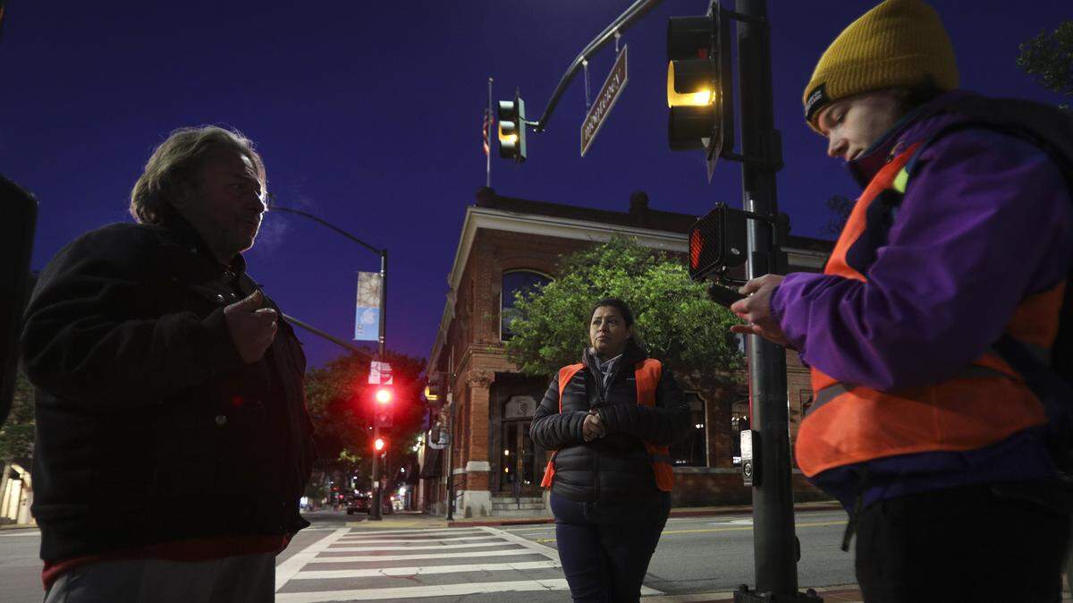 A man who had been out walking all night identified himself as Jeffry Haldae Agiular. Lisa Gutierrez, center, and Jenn Fields fill out a survey with his responses. Volunteers making the Point-In-Time Count of unhoused were out before dawn on Jan. 27, 2026.