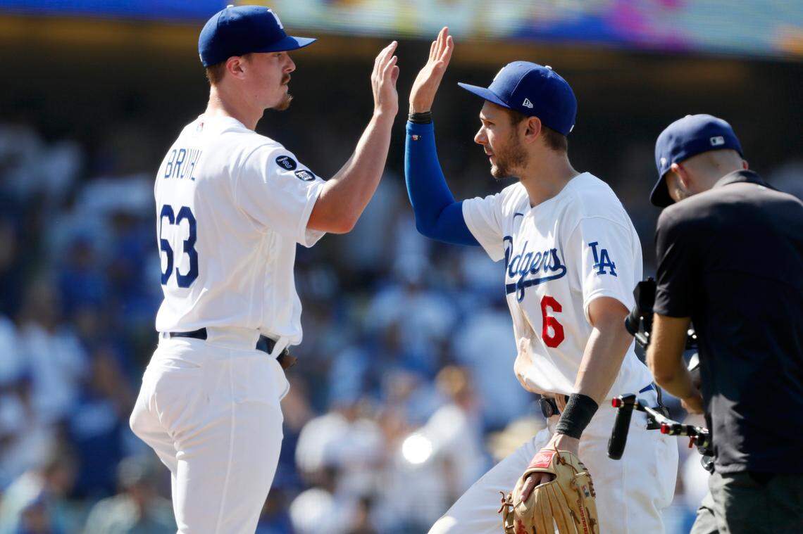 Los Angeles Dodgers relief pitcher Justin Bruihl, left, celebrates with Trea Turner after the Dodgers defeated the Los Angeles Angels 8-2 in a baseball game in Los Angeles, Sunday, Aug. 8, 2021. The former Cal Poly lefthander made his Major League debut.