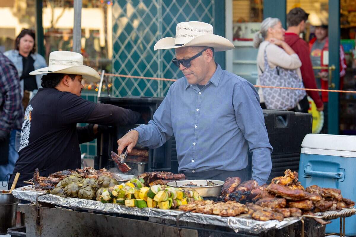 Victor Albarran, owner of Vix Creek Saloon, grills a piece of tri-tip at the restaurant’s booth at the Downtown SLO Farmers Market on June 25, 2025. Albarran, a former F. McLintocks employee, opened his restaurant in the former McLintocks location in Arroyo Grande, and now occupies McLintocks space at the market.