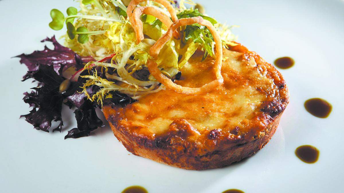 Koberl at blue's warm gruyere and onion tart is accompanied by field greens in a pumpkin seed vinaigrette.