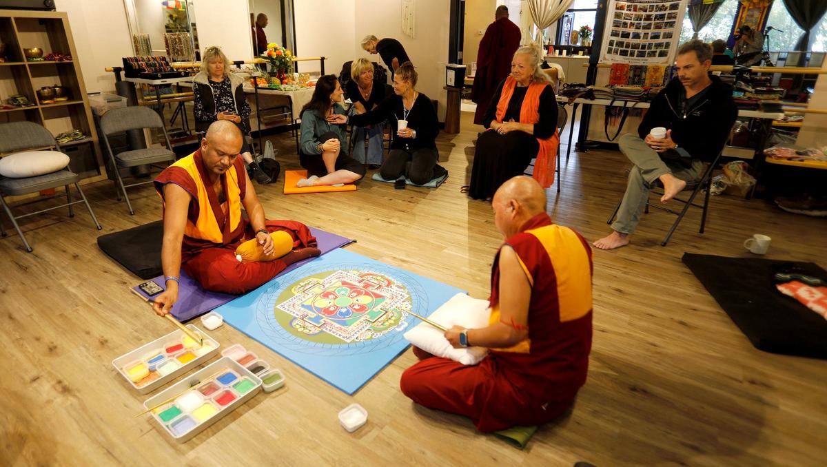 Tibetan monks from India began to build a sand mandala at the Aligned Acupuncture and Wellness Spa in San Luis Obispo on Sept. 24, 2024. They will destroy the mandala on Sept. 27, 2024. Tibetan monks, Lobsang Dhamchoe, left, and Thupten Kunkhen, carefully create the mandala.
