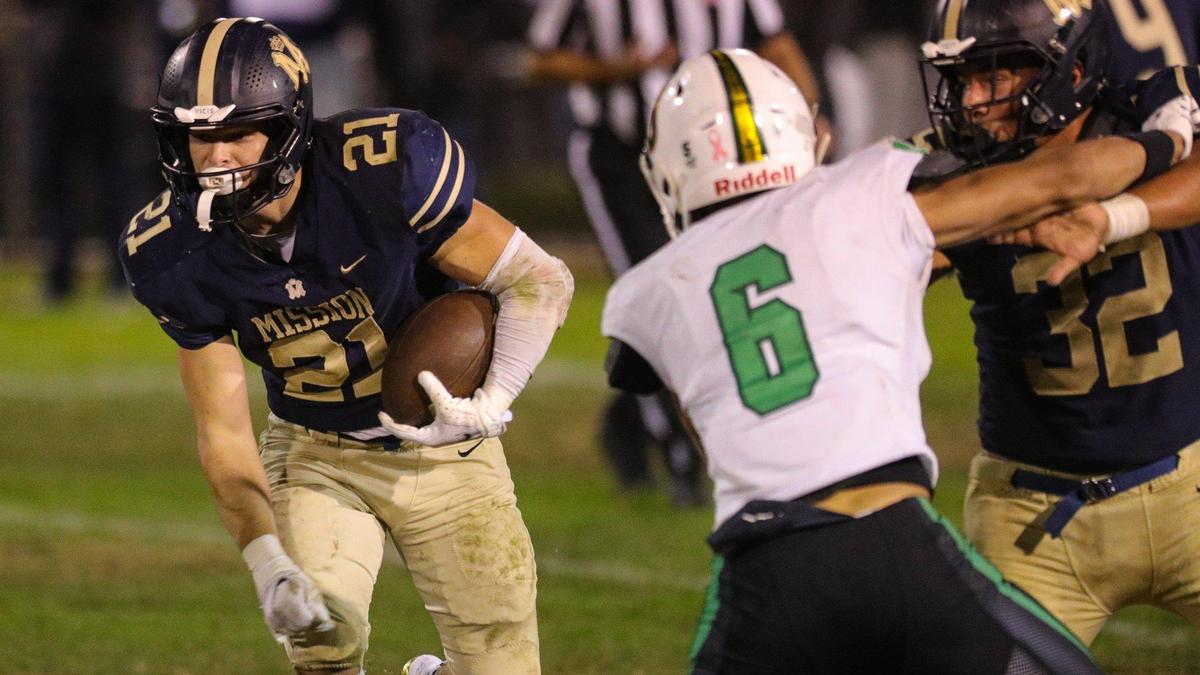 Drew Harrigan looks for an opening as Isaac Townsend blocks. Mission Prep fell to St. Joseph 49-21 on Oct. 28, 2022, in the last game of the regular season, giving the Knights the Mountain League football championship.