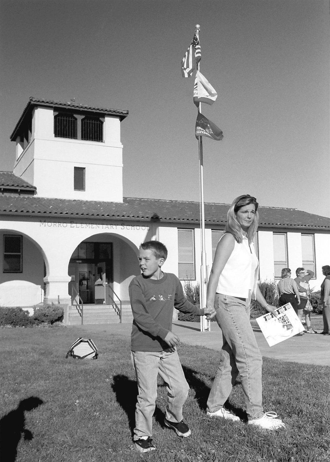 Kim Stultz picks up her son Michael, 9, a third-generation Morro Elementary School student, after class in 2001. She is a second generation student of the school in Morro Bay. The San Luis Coastal school district closed the school and combined it with Del Mar Elementary on the north side of town in at the end of the 2001-02 school year.