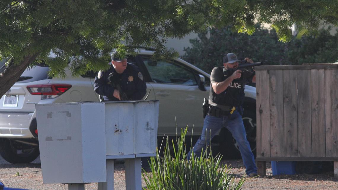 Officers take aim at an apartment across Camilla Court following a shooting Monday, May 10, 2021, in San Luis Obispo. SLOPD Det. Luca Benedetti was killed and Det. Steve Orozco was injured during the service of a search warrant at the apartment of Edward Giron off of Margarita Avenue. Giron was wounded during the exchange and died of a self-inflicted gunshot wound, officials say.
