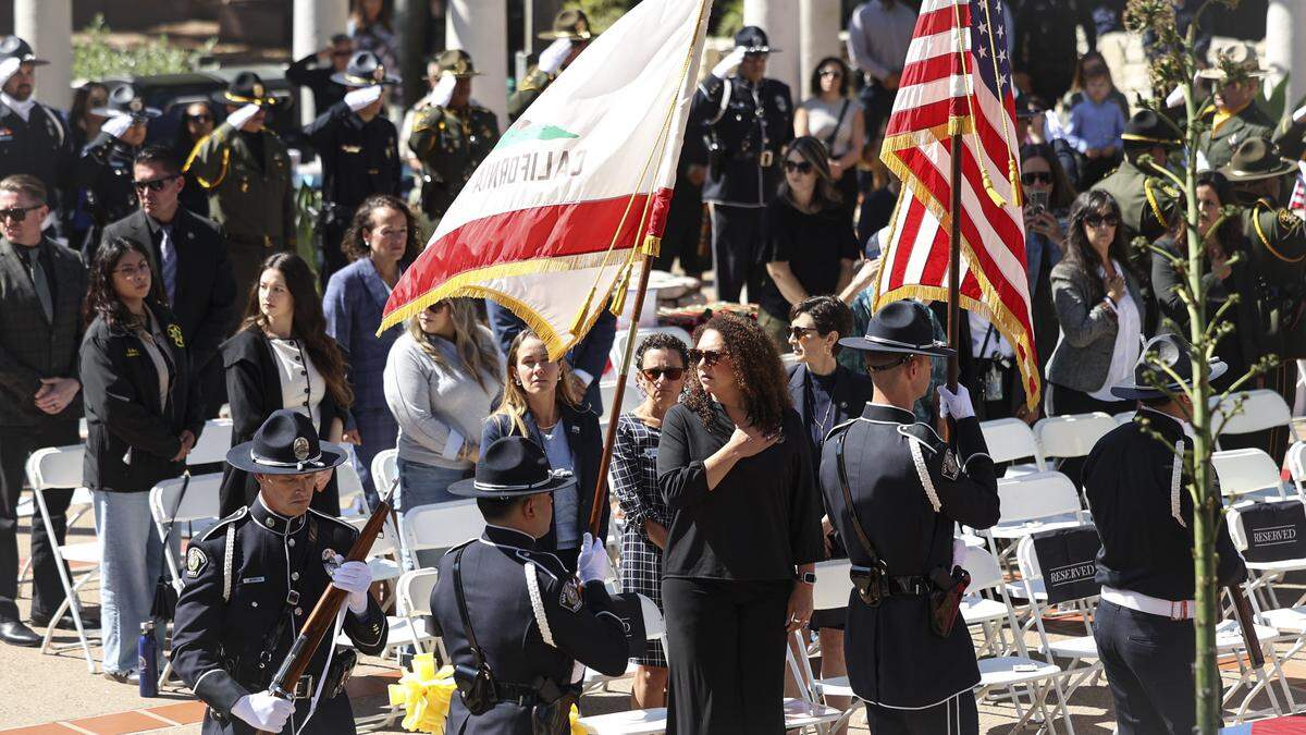 Color guard walks in past San Luis Obispo City Council members Emily Francis and Michelle Shoresman and Mayor Erica A. Stewart. The county’s annual Peace Officers’ Memorial ceremony was held at Mission Plaza on May 7, 2026.