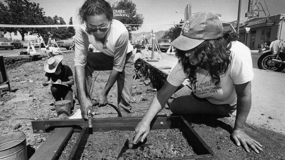 Michael Lara, left, and Cathy Jacobs, both of San Luis Obispo, dig for century-old pottery in 1987 at the old Chinatown section of San Luis Obispo that is now a parking garage.