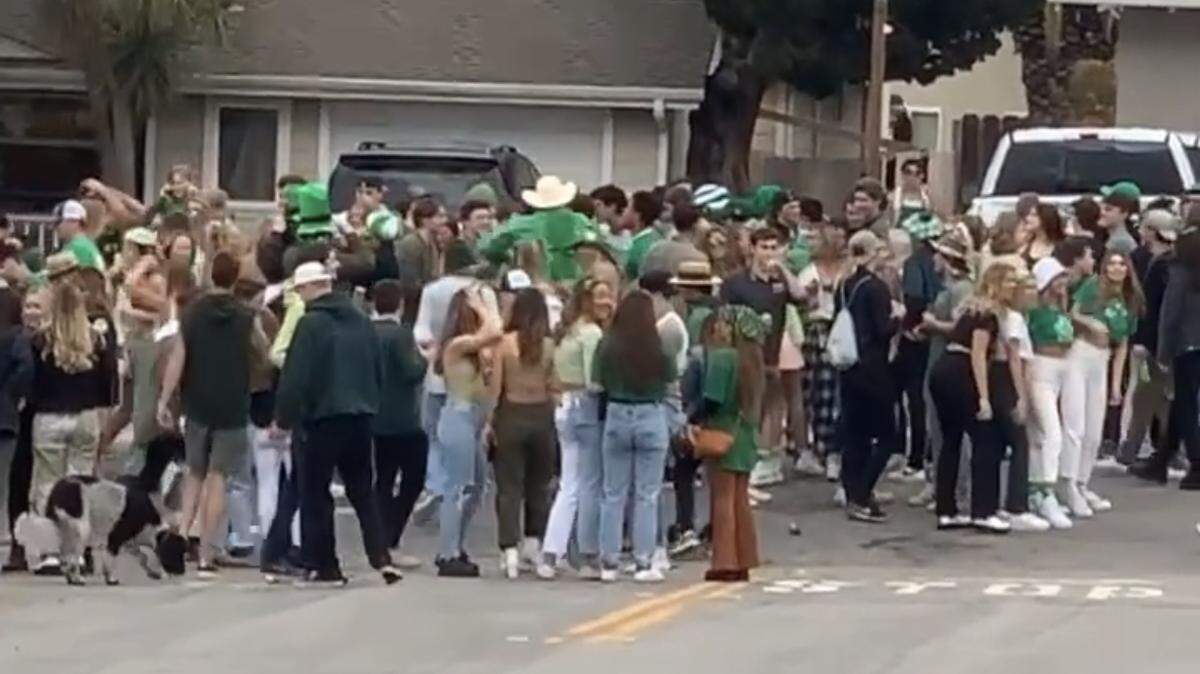 Cal Poly students gather in the street to celebrate “St. Fratty’s Day” on Saturday morning, March 13, 2021, in San Luis Obispo, Calif., despite COVID-19 health orders.